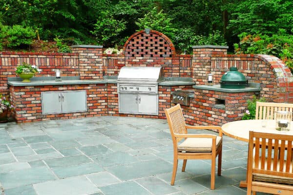 Bluestone patio with brick outdoor kitchen and brick lattice wall in Atlanta