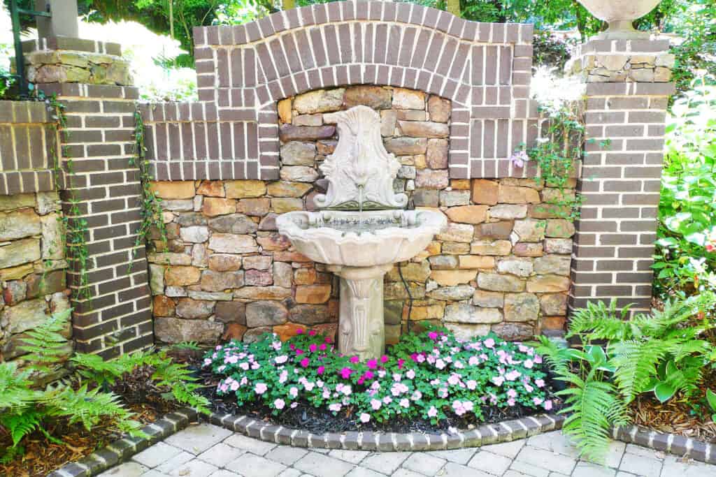 Fountain on stone and brick wall in courtyard Decatur